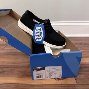 Hey Dude Black Sneakers with Lace-Up Design and White Sole